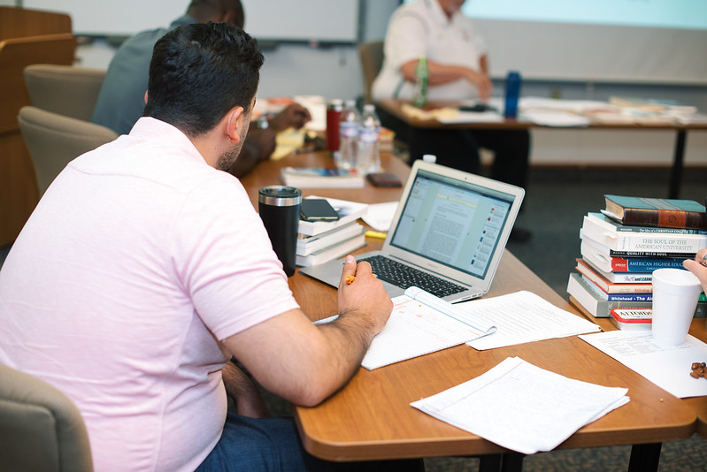 49652215713 F4c659f6ce C Student working at a laptop with his coffee in a classroom