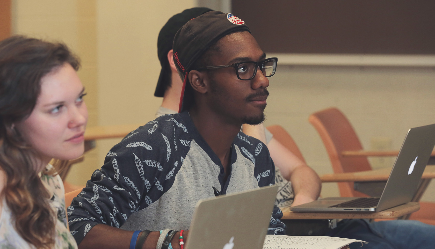 two students listen attentively in class