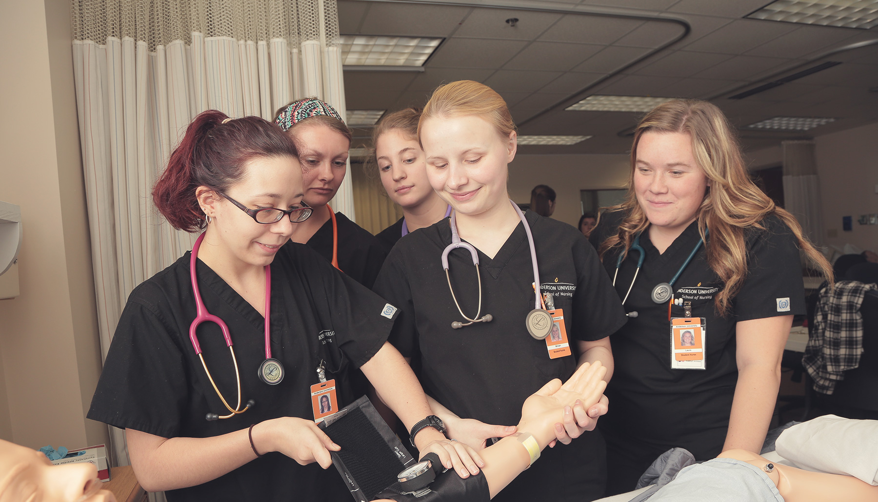 nursing students put a blood pressure cuff on Sim-Man