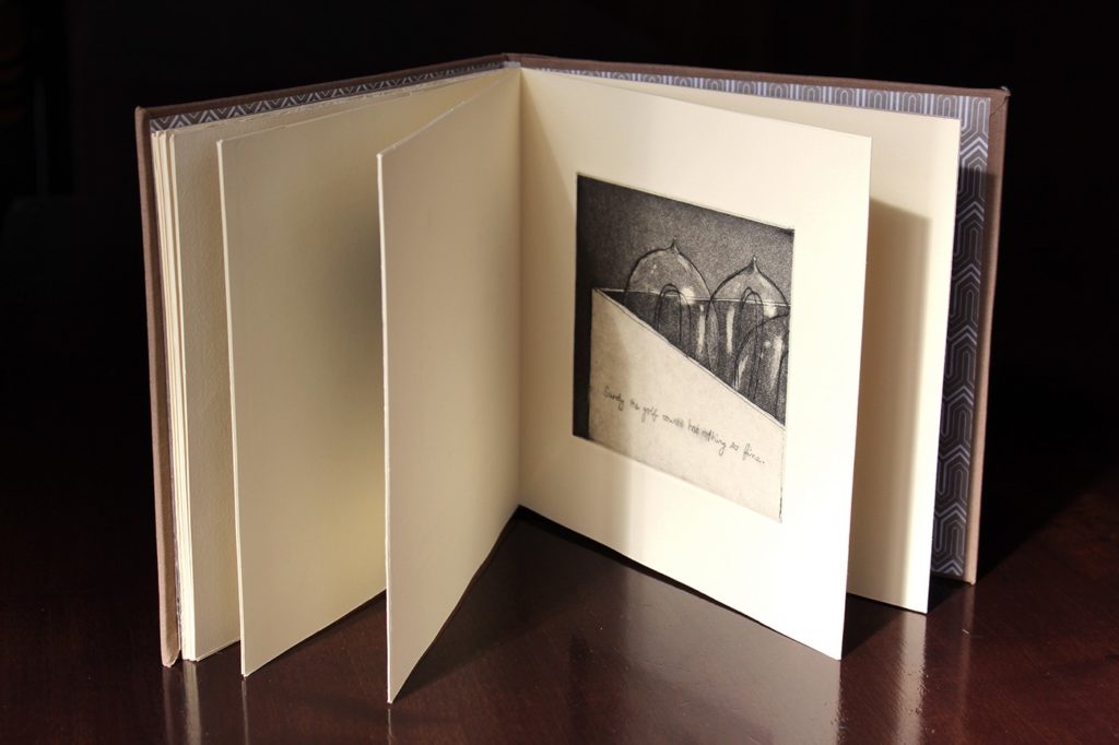 open book sitting on a desk with photo image on inside
