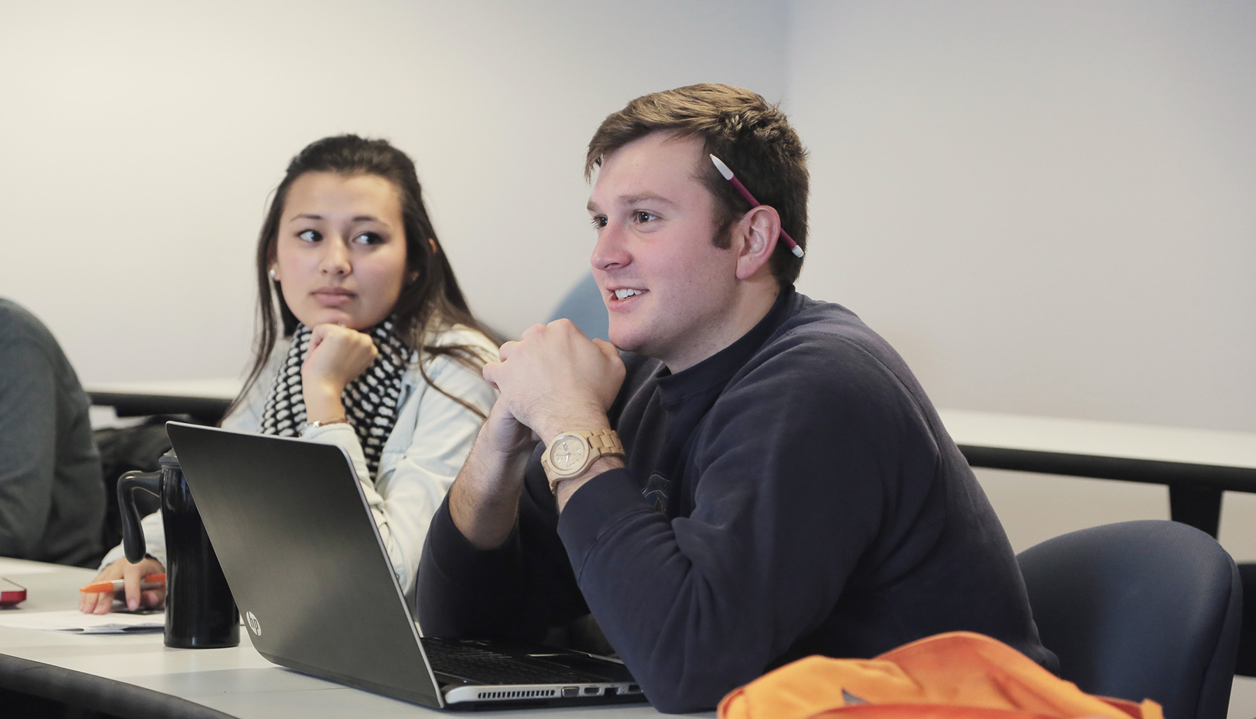 two students listen attentively in class