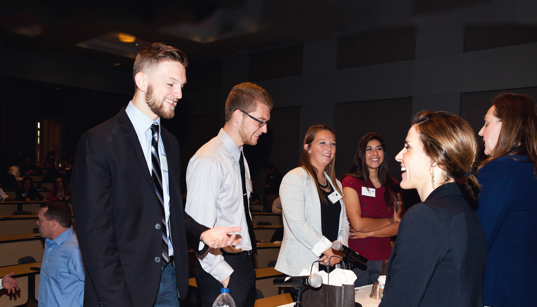 students smiling at a conference