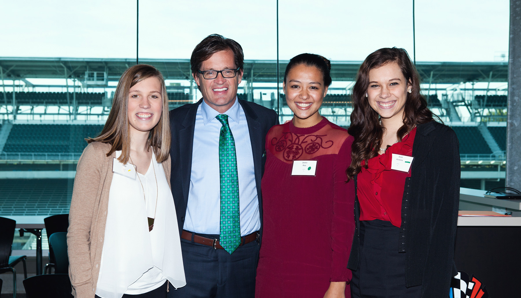 four people smiling at the camera
